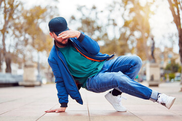 breakdancer guy performing downrock or floor based footwork on the street	