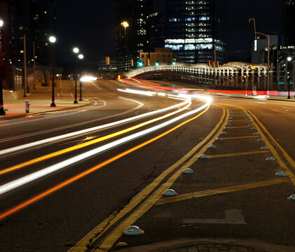 Atlanta, Georgia USA - 2 17 2024: Light trail photograph of passing cars at night in city.  Atlanta on street near Atlantic Station in Atlanta. Abstract photography with light trails causing cars to l