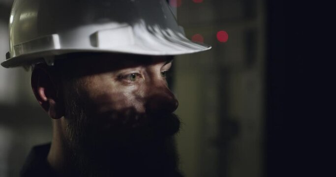 Man, electrician and dark working on installation for light wiring, maintenance or safety protocol. Male person, hard hat and cable professional as handyman for energy system, control room or service