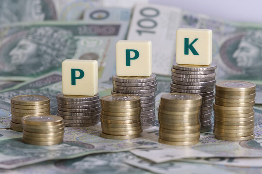 PPK, Pracownicze Plany Kapitalowe, letters on polish zloty coins, banknotes. PPK is a Employee Capital Plans private savings retirement plan in Poland contributed to by the employer and the state.