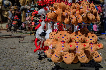 Traditional Alsatian gingerbread man plush toys and stork stuffed animals on display at a souvenir store in old town, Strasbourg, France