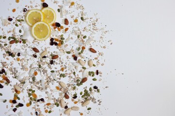 Organic seeds and spices with slices of lemon on white background