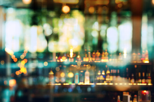 blur alcohol bottle in bar and pub with blur party light background