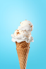 Highly Tempting Vanilla Ice cream cone Held Against Cool Blue Background Summertime Treat - obrazy, fototapety, plakaty
