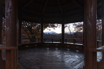 Fototapeta na wymiar View of the wooden pavilion in autumn