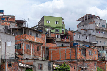 Shacks in a favela in the middle of the Atlantic Forest. Fragile buildings on the outskirts of São...