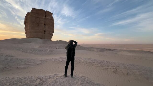 A photographer at an amazing rock formation in the Arabian desert is called the Devil's Thumb, or the Judah Thumb. Judah (the town) is nearby, 160 kilometers from Dhahran, Saudi Arabia.