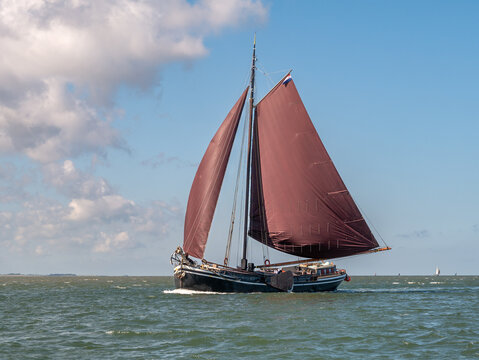 Historic tjalk charter ship sailing on Waddensea in the Netherlands