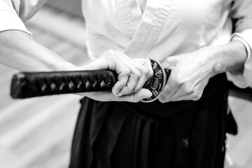 Traditional Japanese katana sword in hands, close-up view.
