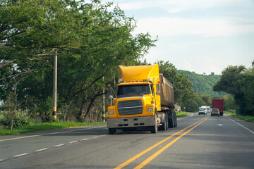 Fototapeta na wymiar Yellow truck on a country road in Colombia.