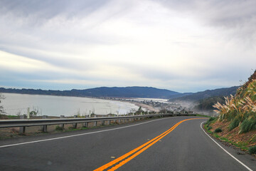 It's a scenic route, perfect for a relaxing road trip that offers stunning views of the ocean. It captures the calming essence of a leisurely drive along the coast. Coastal Road Car Journey. 