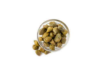 Capers in a bowl isolated on a white background. Marinated caper buds, small salted capparis in bowl, fermented food, pickled capers group.Organic spices and seasonings.