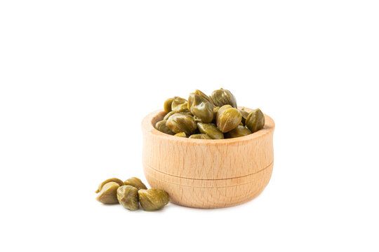 Capers in a bowl isolated on a white background. Marinated caper buds, small salted capparis in bowl, fermented food, pickled capers group.Organic spices and seasonings.