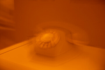 old telephone with a separate receiver and rotary dial on a board, abstract shot like a view from...