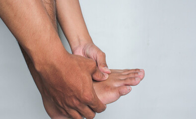 Hand holding sore foot