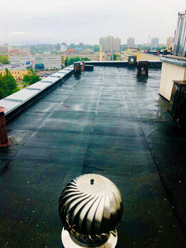 Modern chimney on the roof with view on the city