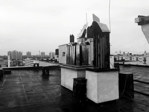 Modern chimney on the roof with view on the city