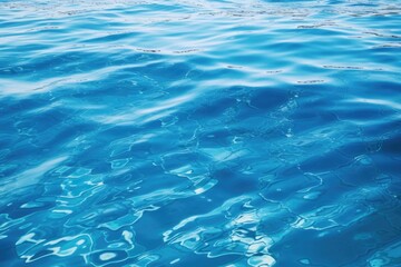 Fototapeta na wymiar Clear blue water with gentle ripples, suitable for various aquatic themes