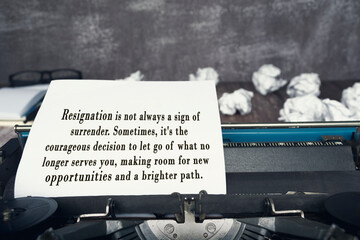 Motivational quote on an old typewriter with trash paper background.