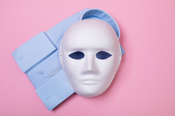 Top view of white mask and shirt on pink background, concept on counterfeit and fake products
