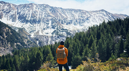 man backpack looking snow mountain