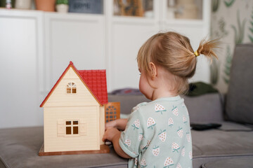A little girl is playing with a dollhouse. Saint Petersburg, Russia - 12 Feb 2024