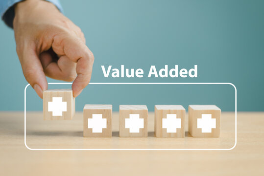 Value added increase benefit concept. Offer positive thing profit to benefit growth development business. Hand place wooden plus icon, add value more feature. Finance business investment strategy