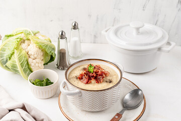 Cauliflower and white bean cream soup with fried bacon