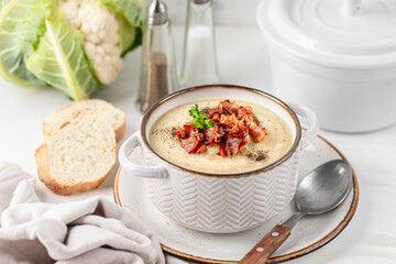 Cauliflower and white bean cream soup with fried bacon - obrazy, fototapety, plakaty