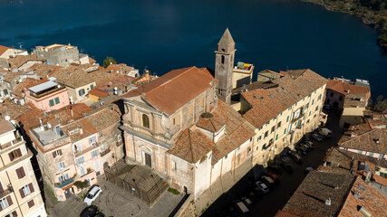 Naklejka premium Aerial view of the church of Santa Maria della Cima. It is a Catholic church in Genzano di Roma, in the metropolitan city of Rome, Italy. In the background the lake of Nemi. 