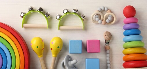 Baby song concept. Flat lay composition with toy musical instruments on white wooden background - obrazy, fototapety, plakaty