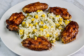 chicken wings  with rice corn and peas