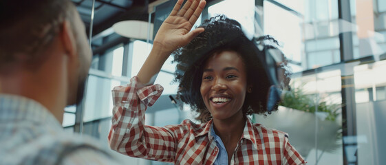 Joyful woman high-fiving in a playful, upbeat exchange with a blurred companion.