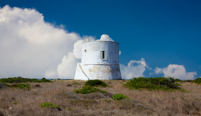 A cylindrical white tower with a flat roof and a small window. Located in Salento, Italy, built in 1569. - 746687346