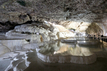 The scenic views of Kaklık cave which is full of dripstones, stalactites and stalagmites. There are also travertine formations and a small thermal lake at the bottom of the cave in Denizli, Turkey