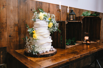 Tiered Wedding Cake Decorated with Yellow Floral Accents