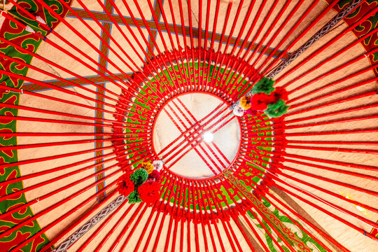 Yurt interior. Shanyrak impotant element of traditional Kyrgyz tent. Tunduk symbol in center of Kyrgyzstan national flag. National decoration on roof Embroidery and patterns of nomads central Asia.