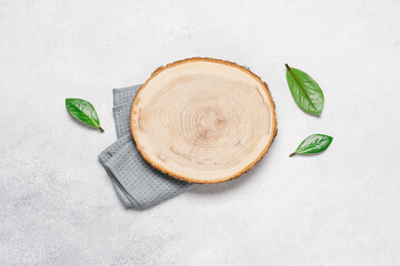 Wooden slice cut on alight background. Podium for advertising eco products top view