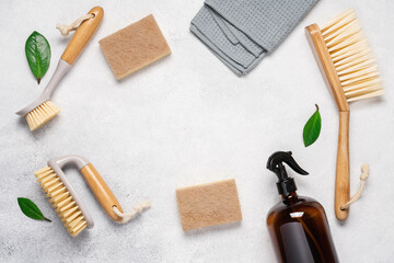 Cleaning supplies on a light background with copy space. Brushes, sponges, rags, bottle of...