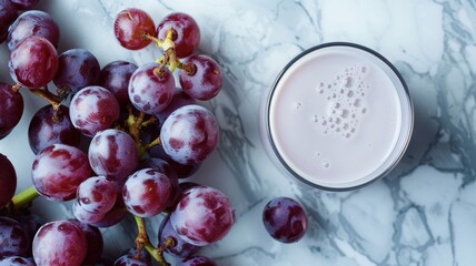 glass filled with pink grape milk surrounded by clusters of fresh grapes , invoking a sense of...