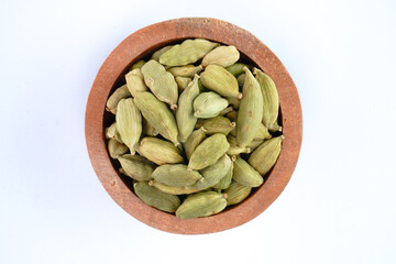 Dried cardamom in the bowl concept background