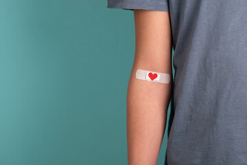 Arm with plaster and heart, blood cells, donate plasma, world blood donor day, health care,...