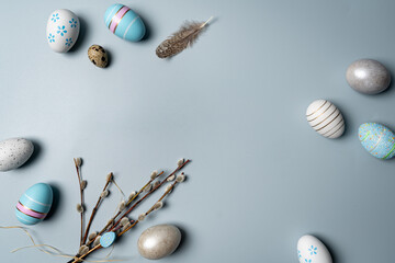 Happy Easter composition for easter design. Elegant Easter eggs with willow branches on pastel blue...