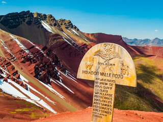 Panoramic viewpoint of the Red Valley (valle rojo) with wooden sign in foreground, Cusco region, Peru - 746703506
