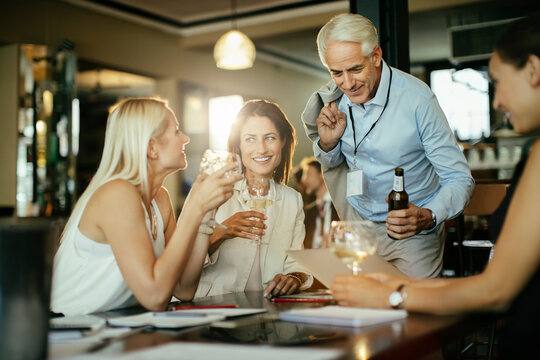 Colleagues drinking together after work in a bar