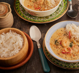 Bowls of Thai styled seafood soup with rice.