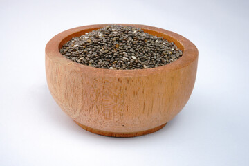 Chia seeds on a wooden bowl concept background