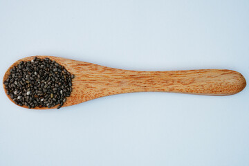Chia seeds on a wooden spoon concept background