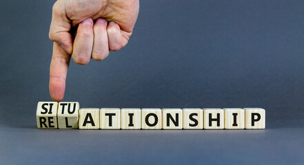 Relationship or situationship symbol. Concept word Relationship situationship on wooden cubes. Beautiful grey background. Businessman hand. Business relationship situationship concept. Copy space.