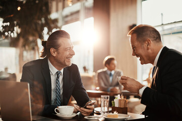 Two businessmen having a meeting at a indoor cafe and having a discussion